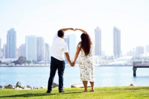 Photo of couple making a heart with their arms during San Diego date ideas